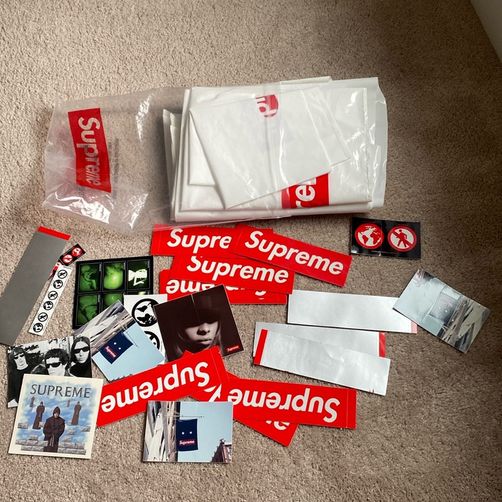 Multiple supreme shopping bags and stickers